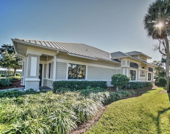 Orthodontist office of Morejon + Andrews Orthodontics at Ormond Beach, image of building with palm trees