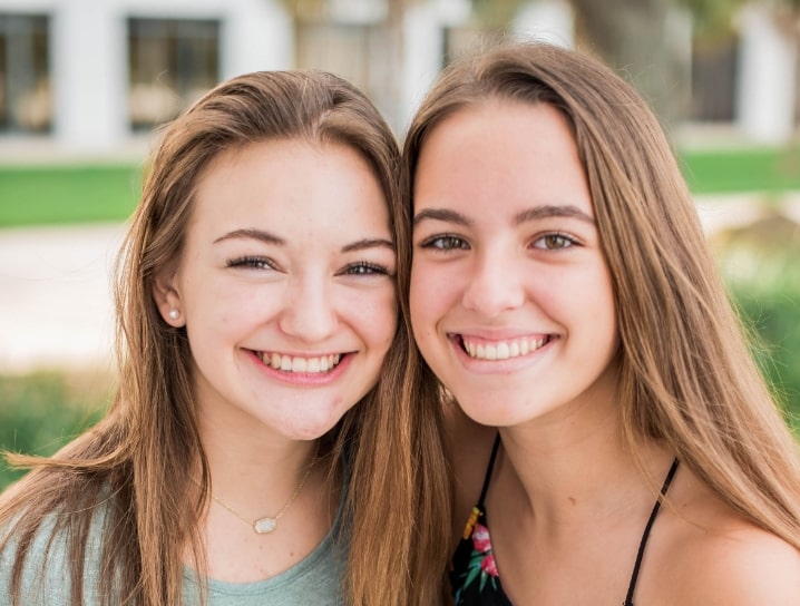 teen sisters posing after wearing braces for teens