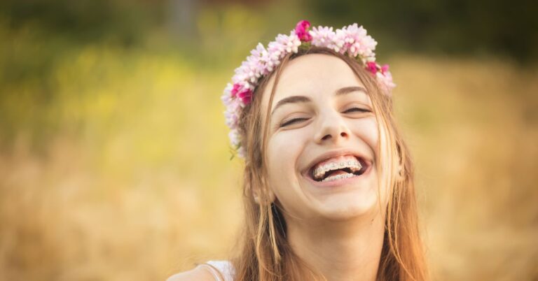 teen with braces, wears flower crown and laughs about What foods to eat with braces