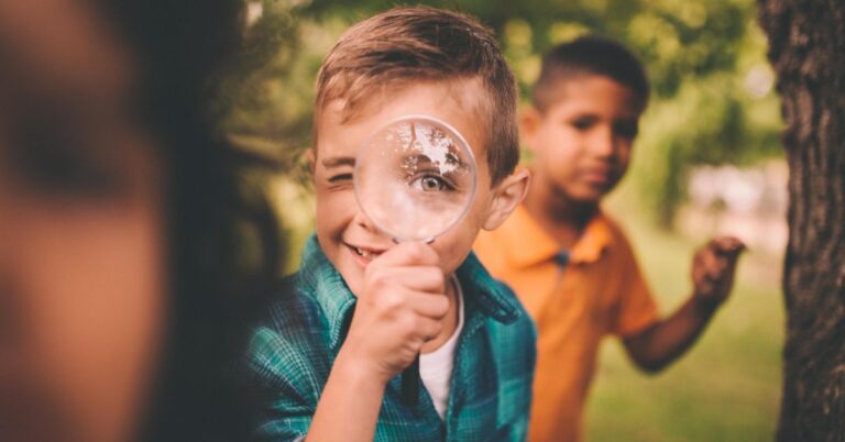 kid with a magnifying glass learns about Early orthodontic treatment